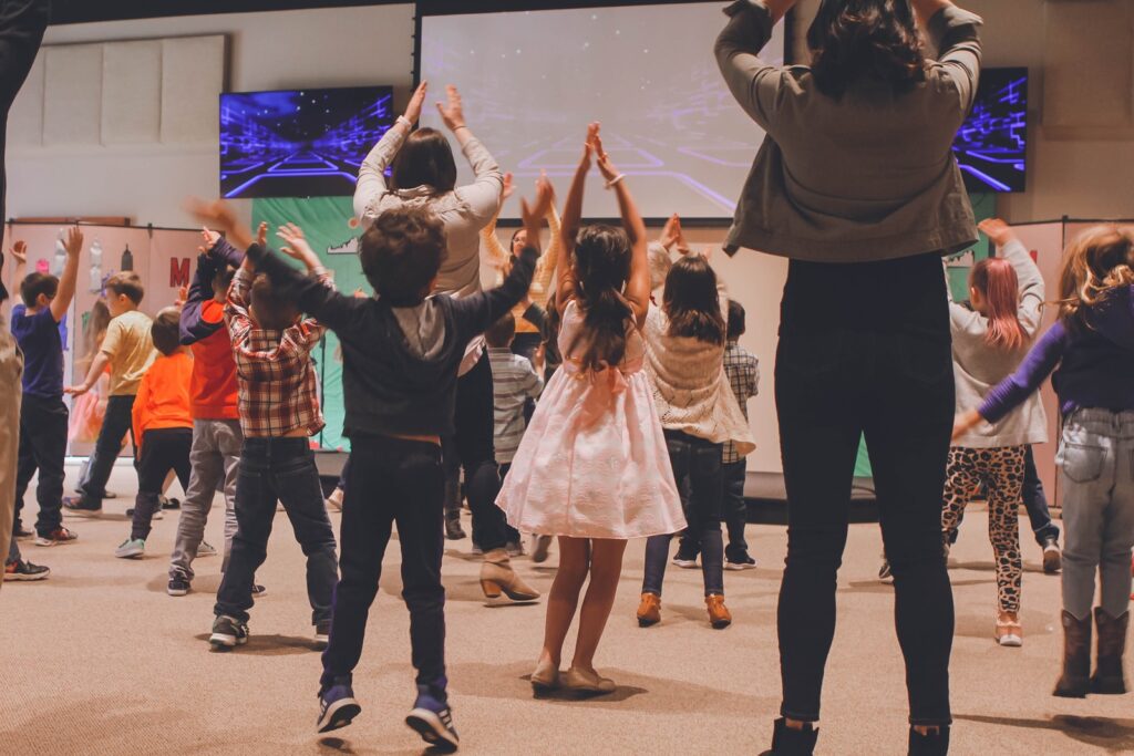 women and children dancing inside room